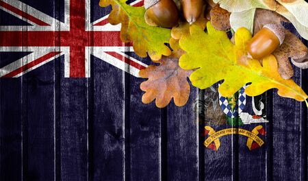 South Georgia and the South Sandwich Islands flag on autumn wooden background with leaves and good place for your text.の写真素材