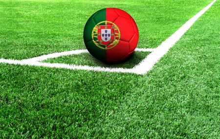 soccer ball on a green field, flag of Portugalの写真素材