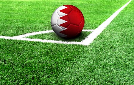 soccer ball on a green field, flag of Bahrainの写真素材