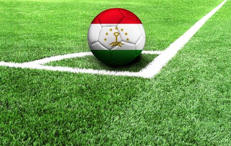 soccer ball on a green field, flag of Tajikistanの写真素材