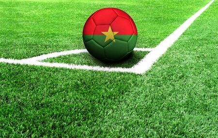 soccer ball on a green field, flag of Burkina Fasoの写真素材