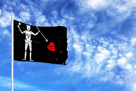 National flag of Blackbeard Pirate on a flagpole in front of blue sky