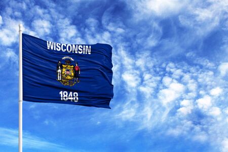 National flag State of Wisconsin on a flagpole in front of blue skyの写真素材
