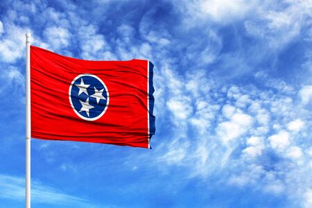 National flag State of Tennessee on a flagpole in front of blue skyの写真素材