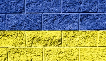 Flag of Ukraine close up painted on a cracked wall