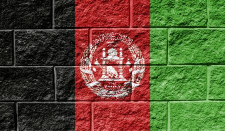 Flag of Afghanistan close up painted on a cracked wallの写真素材