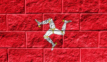 Flag of Isle Of Man close up painted on a cracked wallの写真素材