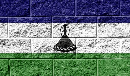 Flag of Lesotho close up painted on a cracked wallの写真素材
