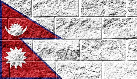 Flag of Nepal close up painted on a cracked wallの写真素材