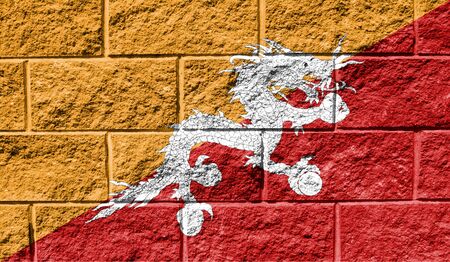 Flag of Butane close up painted on a cracked wallの写真素材
