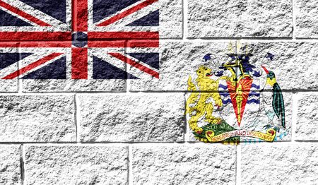 Flag of British Antarctic Territory close up painted on a cracked wallの写真素材
