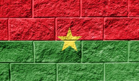 Flag of Burkina Faso close up painted on a cracked wallの写真素材