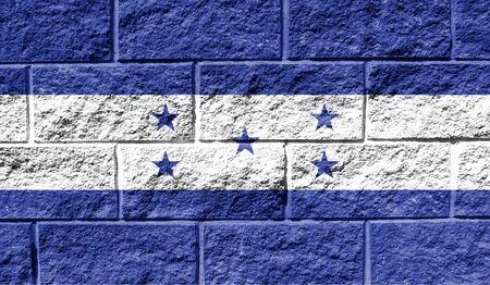 Flag of Honduras close up painted on a cracked wallの写真素材