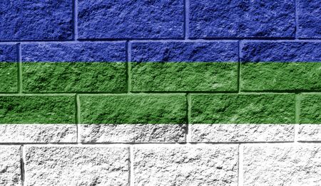 Flag of Komi close up painted on a cracked wallの写真素材