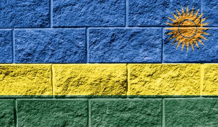 Flag of Rwanda close up painted on a cracked wallの写真素材