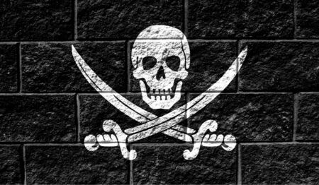 Flag of Pirates black close up painted on a cracked wallの写真素材