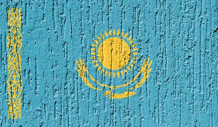 Flag of Kazakhstan close up painted on a cracked wallの写真素材