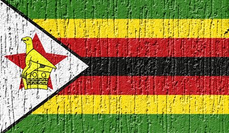 Flag of Zimbabwe close up painted on a cracked wallの写真素材