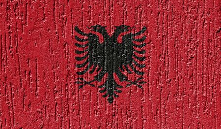 Flag of Albania close up painted on a cracked wallの写真素材