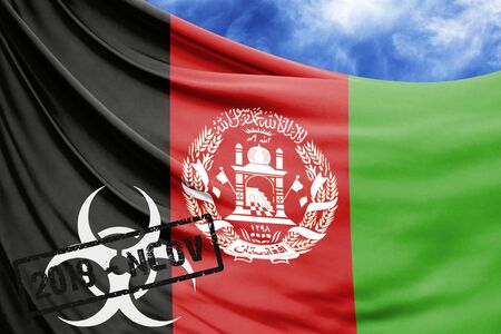 Novel coronavirus disease named 2019-nCoV with Afghanistan flag closeup on blue sky backgroundの写真素材