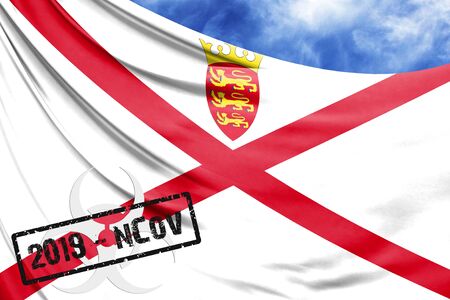 Novel coronavirus disease named 2019-nCoV with Jersey flag closeup on blue sky backgroundの写真素材