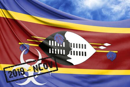 Novel coronavirus disease named 2019-nCoV with Swaziland flag closeup on blue sky backgroundの写真素材