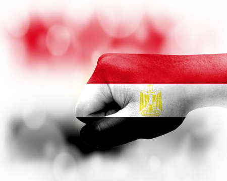 Flag of Egypt painted on male fist, strength, power, concept of conflict. On a blurred background.の写真素材