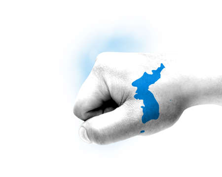 Flag of Korean Unification painted on male fist, strength, power, concept of conflict. On a blurred background.の写真素材