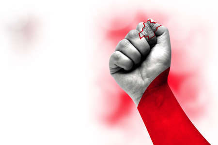 Flag of Malta painted on male fist, strength, power, concept of conflict. On a blurred background.の写真素材