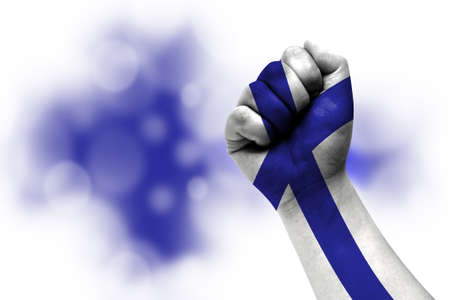 Flag of Finland painted on male fist, strength, power, concept of conflict. On a blurred background.の写真素材