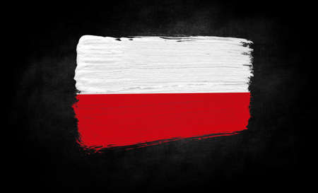 smear of paint in the form of the flag of Poland close-up on a black backgroundの写真素材