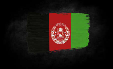 smear of paint in the form of the flag of Afghanistan close-up on a black backgroundの写真素材