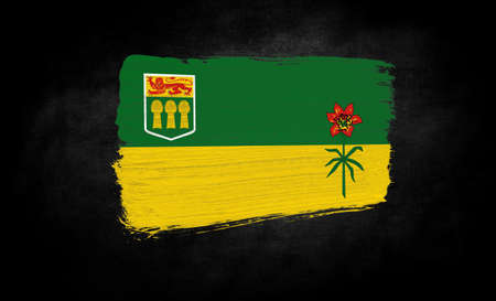 smear of paint in the form of the flag of Saskatchewan close-up on a black backgroundの写真素材