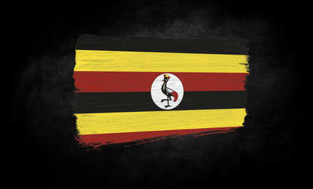 smear of paint in the form of the flag of Uganda close-up on a black backgroundの写真素材
