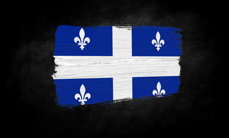 smear of paint in the form of the flag of Quebec close-up on a black backgroundの写真素材