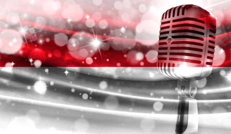 Microphone on a background of a blurry Monaco flag close-up, a design concept for your layout with a good place for text and images.の写真素材