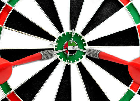 Close-up of a dart board with an imprinted flag of United Arab Emirates in the center. The concept of achieving goals.の写真素材