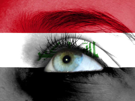 Close up view of a young girl. The flag of Iraq is painted on the girl face.の写真素材
