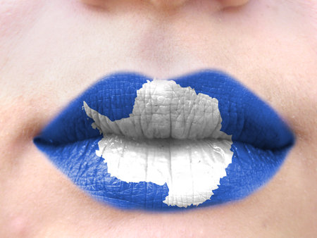 Female lips close up with a picture flag of Antarctic. learning languages.の写真素材