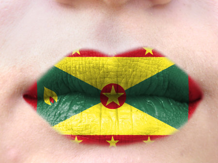 Female lips close up with a picture flag of Grenada. learning languages.の写真素材