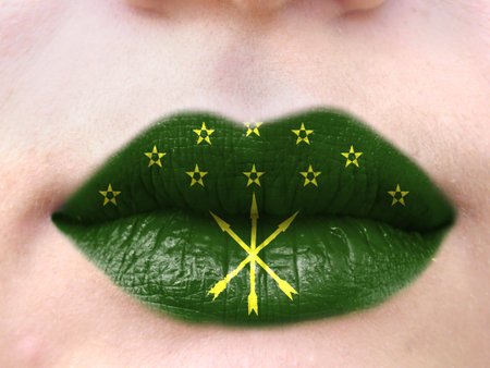 Female lips close up with a picture flag of Adygea. learning languages.の写真素材