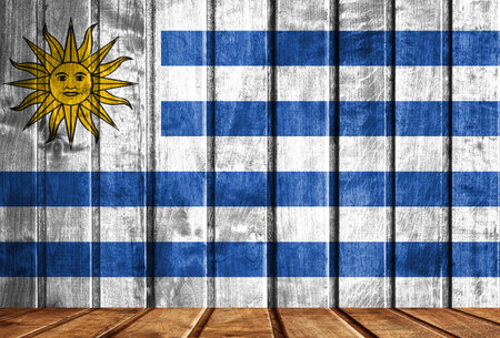Wooden background with a flag of Uruguay. There is a place for your text in the photo.の写真素材