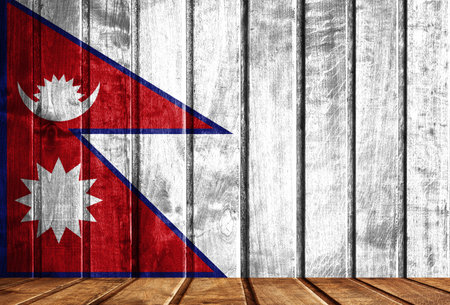 Wooden background with a flag of Nepal. There is a place for your text in the photo.の写真素材