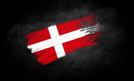 smear of paint in the form of the flag of Denmark close-up on a black backgroundの写真素材