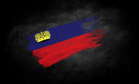 smear of paint in the form of the flag of Liechtenstein close-up on a black backgroundの写真素材