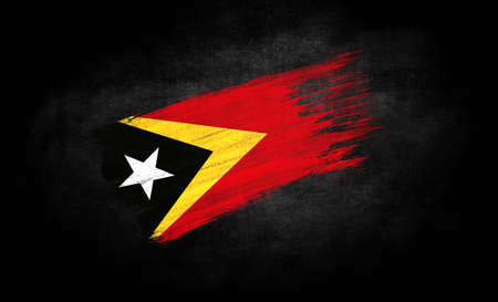 smear of paint in the form of the flag of East Timor close-up on a black backgroundの写真素材