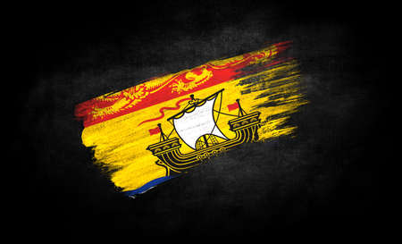 smear of paint in the form of the flag of New Brunswick close-up on a black backgroundの写真素材