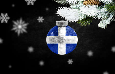 Happy new Year 2021, flag of Quebec on a christmas toy, decorations isolated on dark background. Creative christmas concept.の写真素材