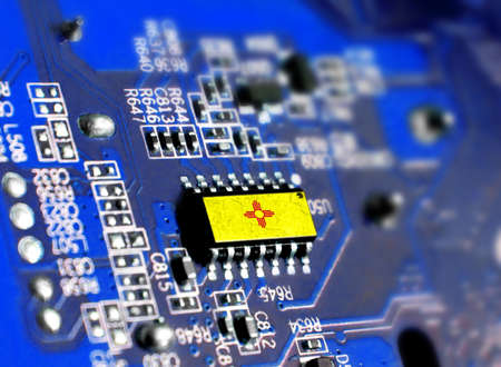 Electronic board with embedded microchip and shown flag State of New Mexico. The concept of modern computer technologies.の写真素材
