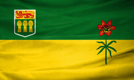 Realistic flag of Saskatchewan on the wavy surface of fabricの写真素材